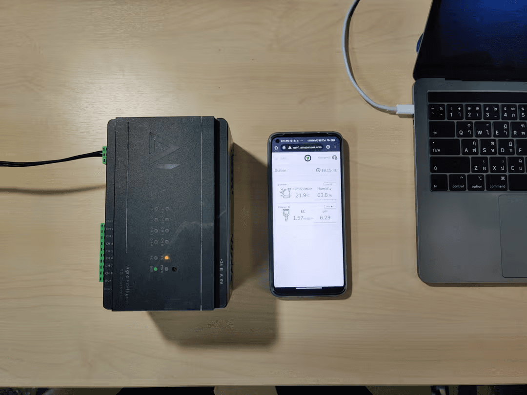 Smartgrobot controller connected beside a phone displaying live smart farming readings